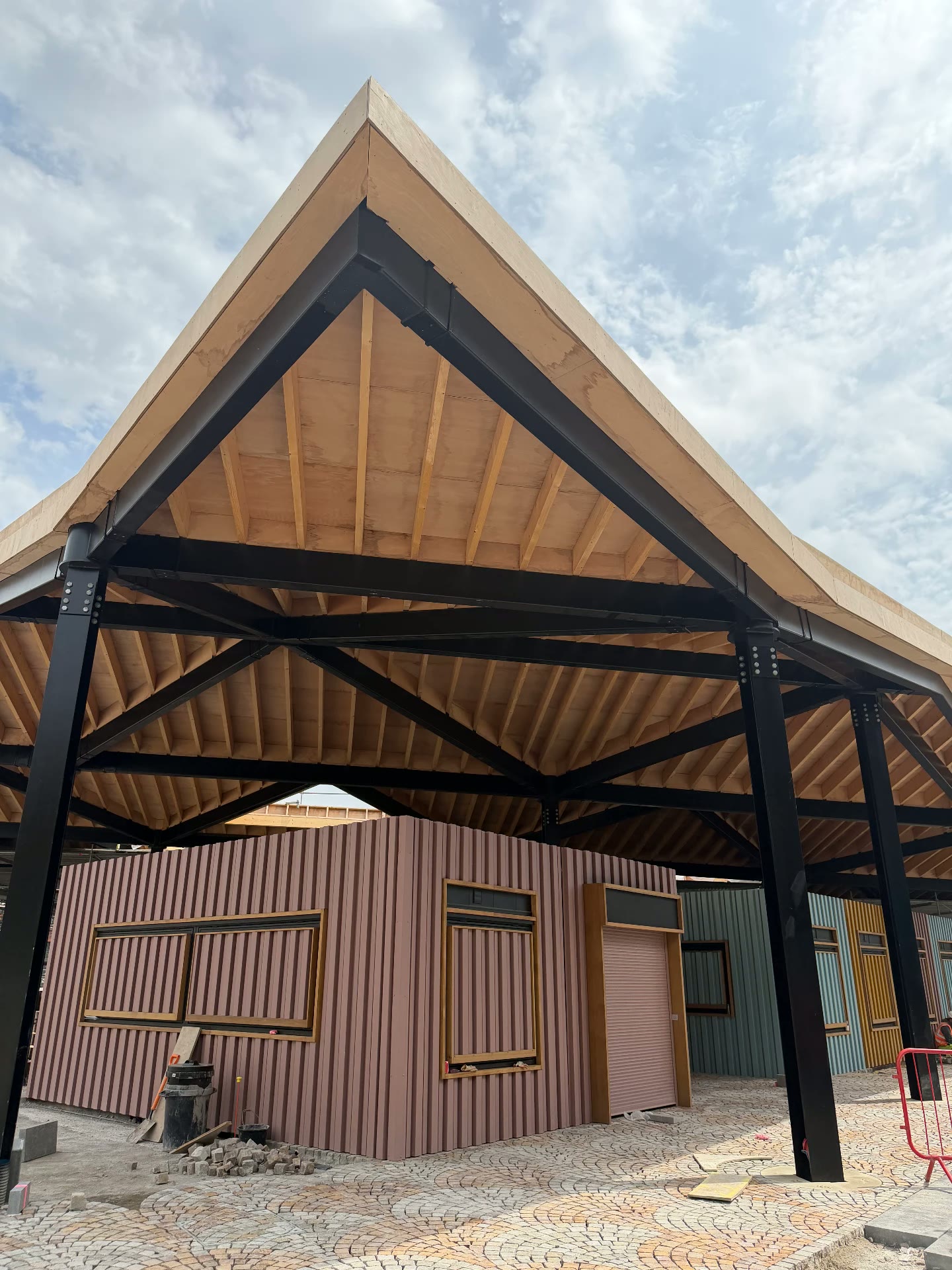 Colourful trading pods beneath the new timber canopy at Ashton Markets