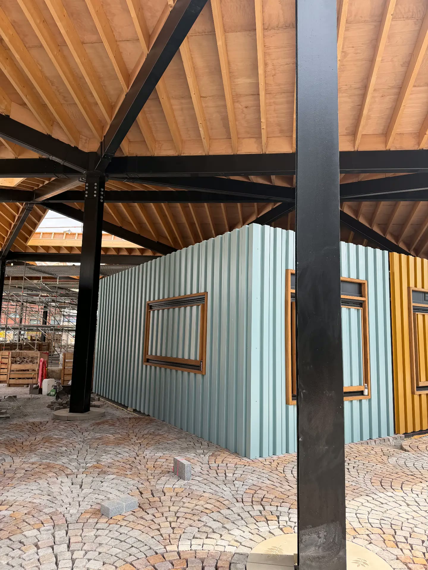 Pastel trading pods under construction inside the new market hall